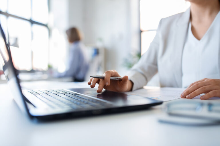 Business woman with a laptop working at office